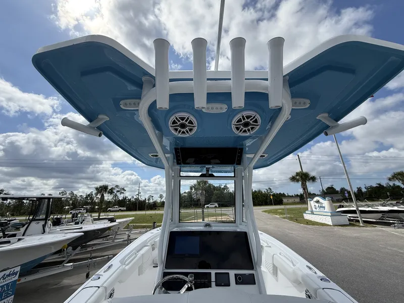 Slide: The Image of Tidewater 272 CC Adventure 2026 with blue canopy and fishing rod holders. - 15