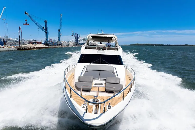 Slide: The Image of Luxury Aicon 75 yacht cruising in open water, 2008 model, with industrial port backdrop. - 10