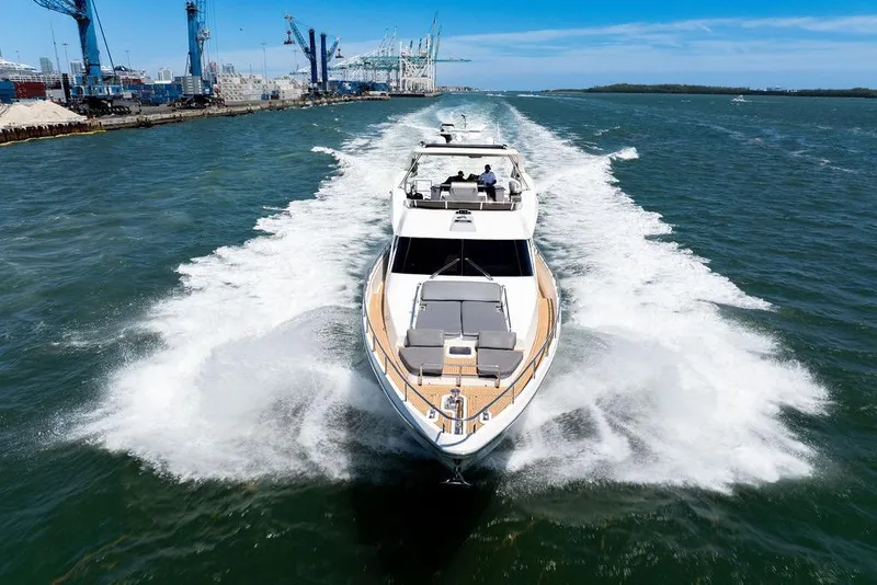 Slide: The Image of Luxury Aicon 75 yacht cruising through water, 2008 model, with cityscape and cranes in background. - 11