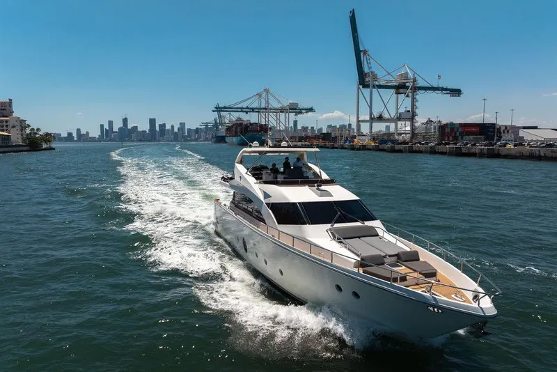 Slide: The Image of Luxury Aicon 75 yacht cruising near city skyline and industrial port, 2008 model. - 12