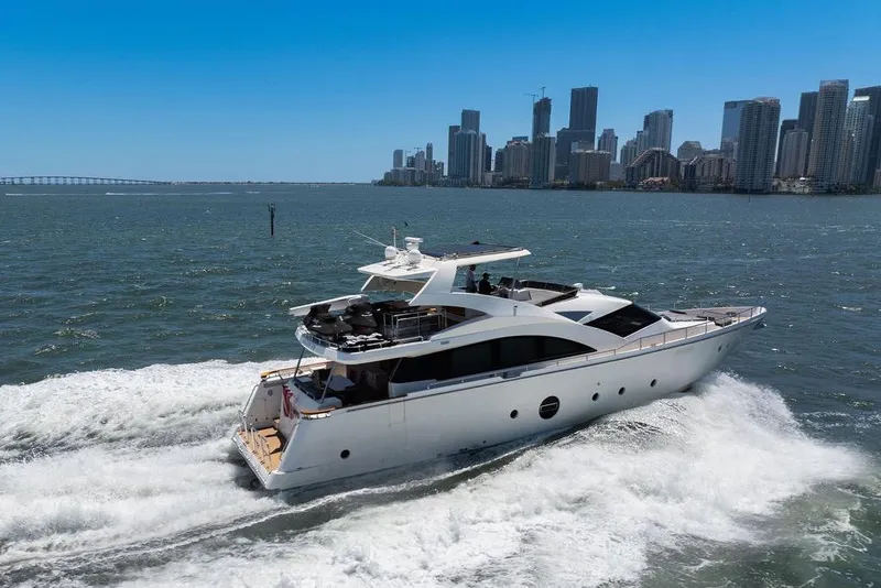 Slide: The Image of Luxurious 2008 Aicon 75 yacht cruising near a city skyline on a sunny day. - 2