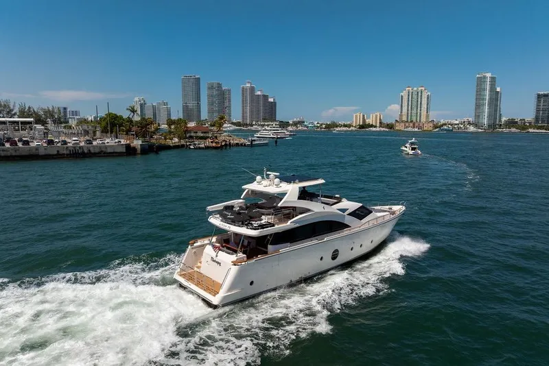 Slide: The Image of Aicon 75 yacht cruising in a city harbor, 2008 model, with skyscrapers in the background. - 8