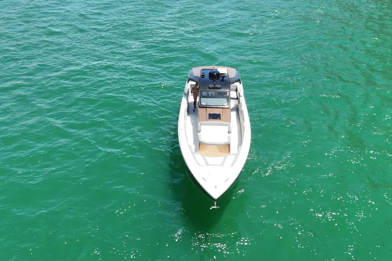 Slide: The Image of 2024 Cigarette 42' Auroris boat on clear turquoise water, aerial view. - 12