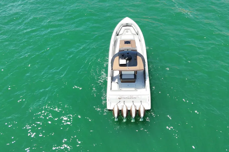 Slide: The Image of 2024 Cigarette 42' Auroris boat cruising on clear turquoise water. - 13