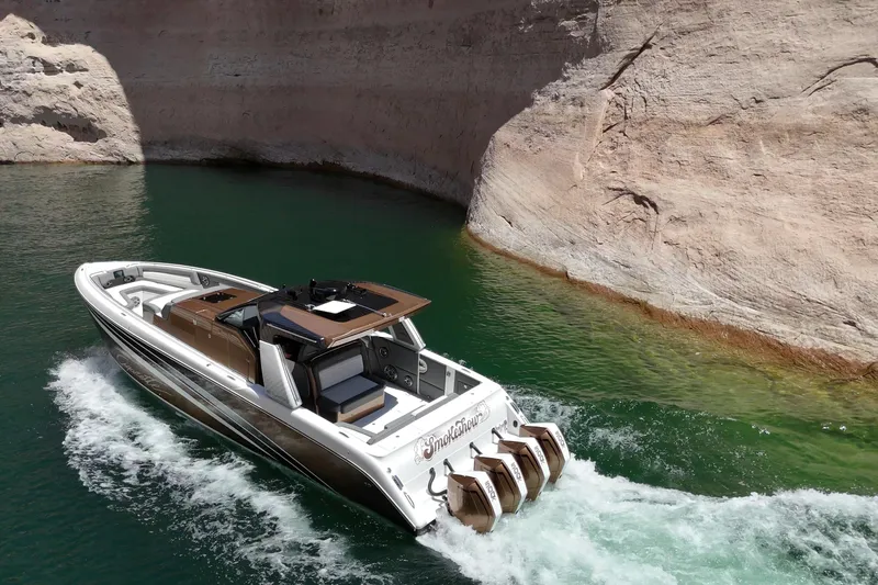 Slide: The Image of 2024 Cigarette 42' Auroris boat cruising in scenic canyon waters. - 14