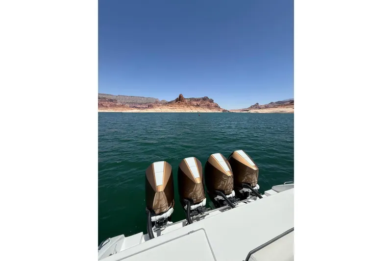 Slide: The Image of 2024 Cigarette 42' Auroris boat with four engines on a scenic lake. - 16