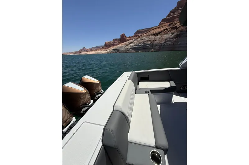 Slide: The Image of 2024 Cigarette 42' Auroris boat on scenic lake with rocky cliffs. - 17
