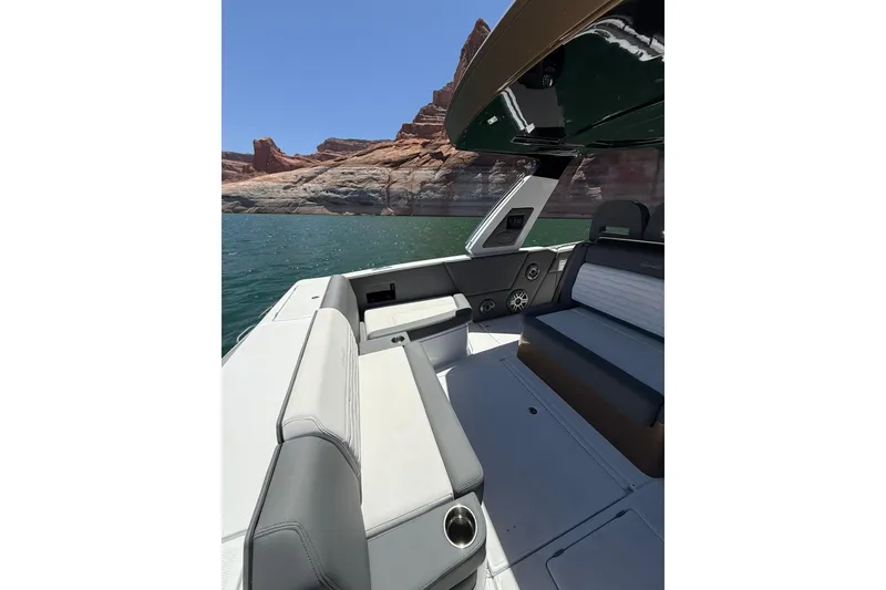 Slide: The Image of 2024 Cigarette 42' Auroris boat interior with scenic lake and rock formations in the background. - 18