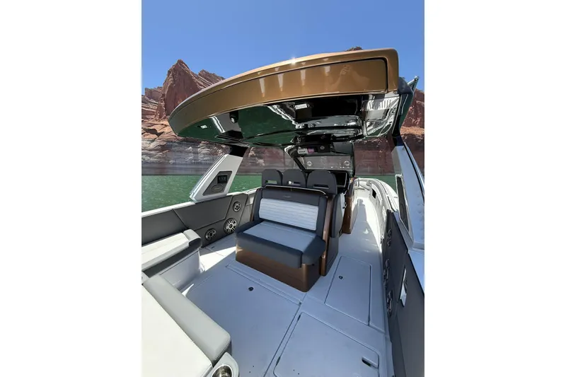 Slide: The Image of 2024 Cigarette 42' Auroris boat interior with sleek seating, under a clear blue sky. - 19