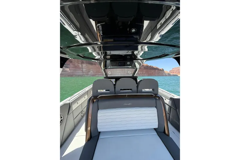Slide: The Image of 2024 Cigarette 42' Auroris luxury boat interior with sleek design on a scenic lake. - 23