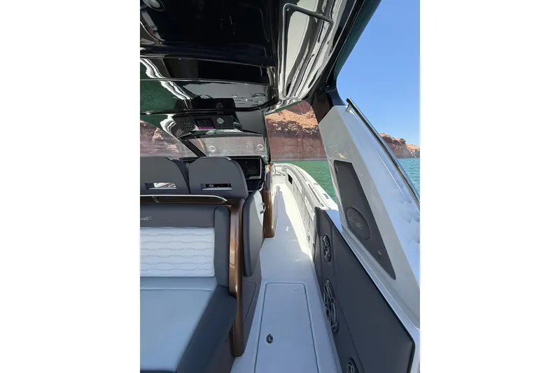 Slide: The Image of 2024 Cigarette 42' Auroris boat interior with sleek design and scenic water view. - 24