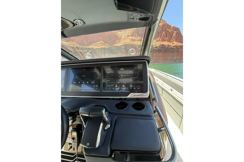 Slide: The Image of Dashboard of 2024 Cigarette 42' Auroris boat with digital controls and scenic water view. - 32
