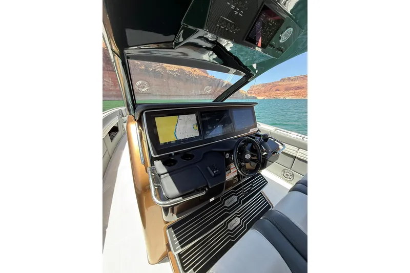 Slide: The Image of 2024 Cigarette 42' Auroris boat cockpit with advanced navigation screens and steering wheel. - 34