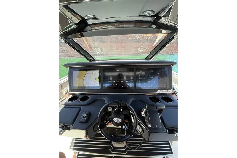 Slide: The Image of 2024 Cigarette 42' Auroris boat dashboard with advanced navigation screens and controls. - 35