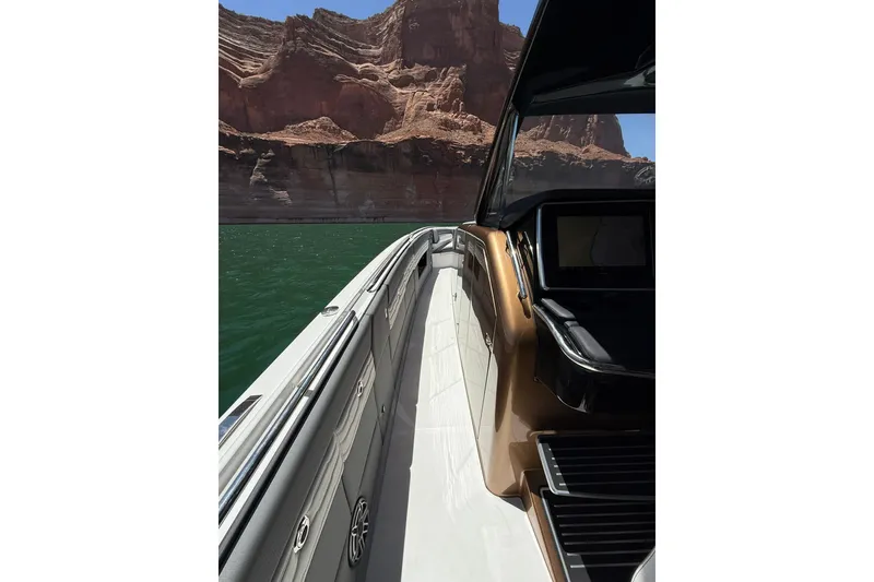 Slide: The Image of 2024 Cigarette 42' Auroris boat cruising near rocky cliffs on a sunny day. - 39