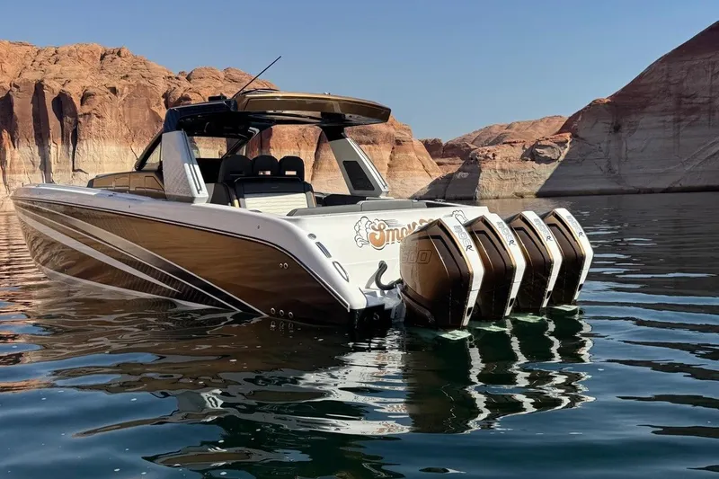 Slide: The Image of 2024 Cigarette 42' Auroris boat with four engines on a scenic lake. - 4