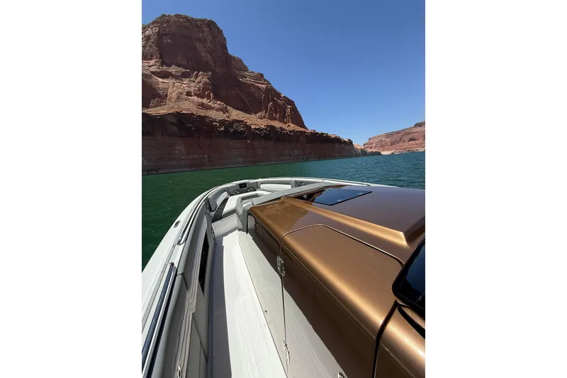 Slide: The Image of 2024 Cigarette 42' Auroris boat cruising near red rock cliffs on a sunny day. - 41