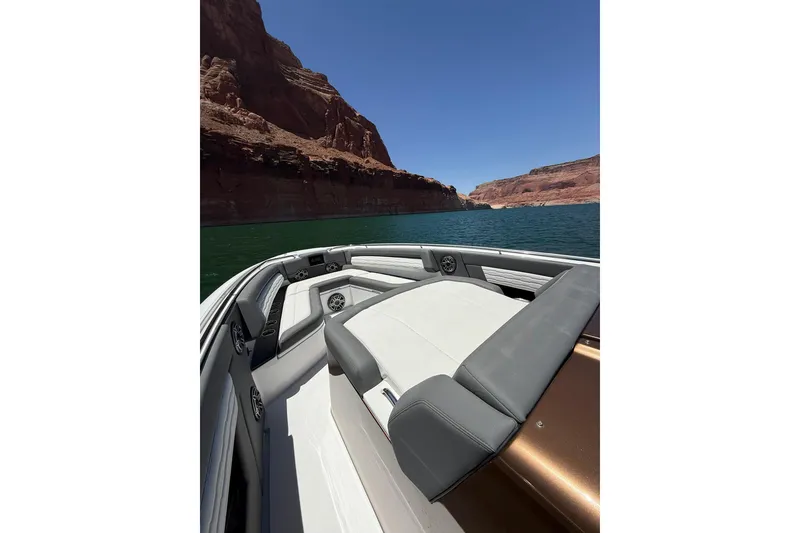 Slide: The Image of 2024 Cigarette 42' Auroris boat cruising through scenic canyon waters. - 43
