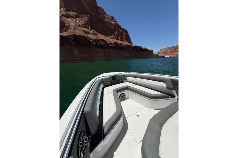 Slide: The Image of 2024 Cigarette 42' Auroris boat on scenic lake with rocky cliffs. - 44