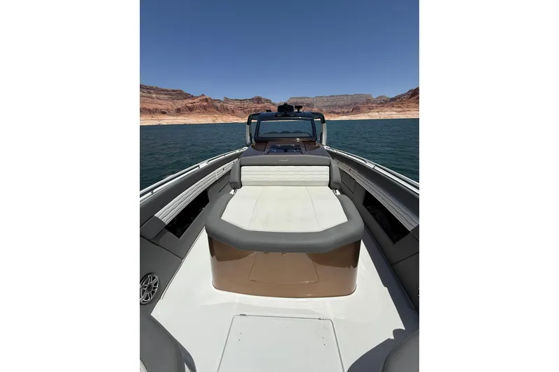 Slide: The Image of 2024 Cigarette 42' Auroris boat on a lake with scenic rocky backdrop. - 47