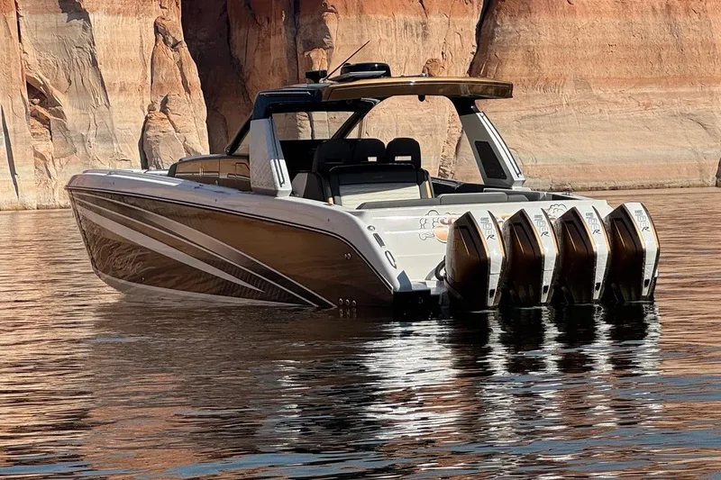 Slide: The Image of 2024 Cigarette 42' Auroris boat with multiple engines on a scenic waterway. - 5
