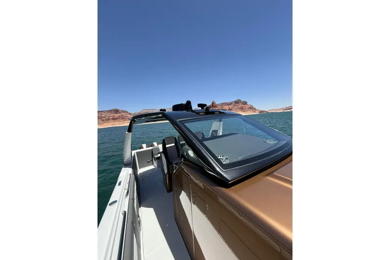 Slide: The Image of 2024 Cigarette 42' Auroris boat on a lake with scenic rocky background. - 50