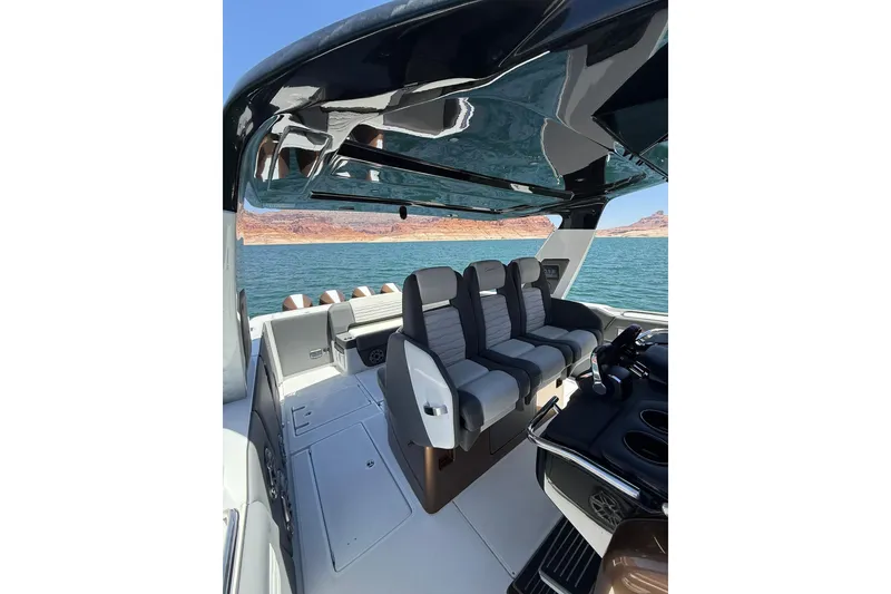 Slide: The Image of 2024 Cigarette 42' Auroris boat interior with sleek seating and scenic water view. - 51