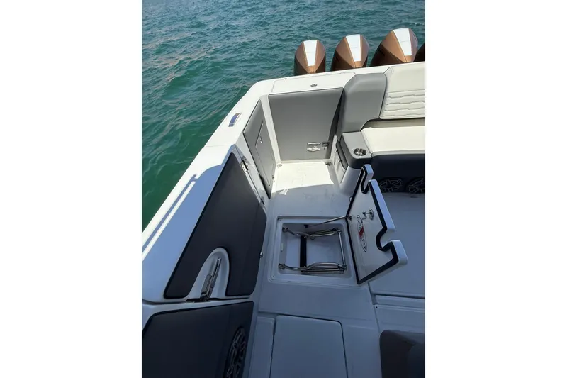 Slide: The Image of 2024 Cigarette 42' Auroris boat interior with open hatch and seating, on water. - 52