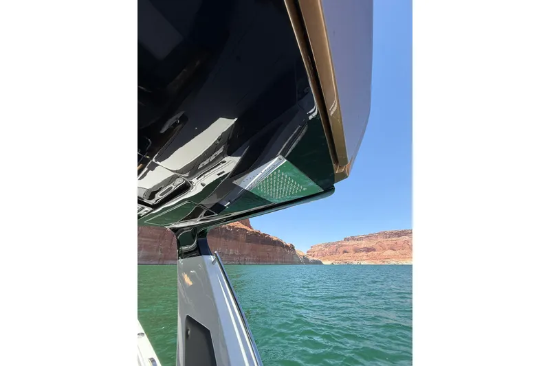 Slide: The Image of 2024 Cigarette 42' Auroris boat on scenic lake with rocky cliffs. - 54