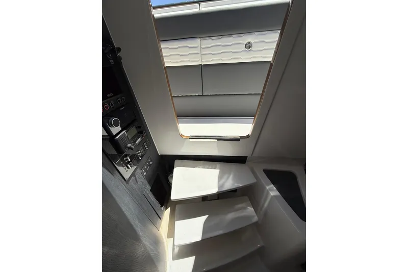 Slide: The Image of Interior view of 2024 Cigarette 42' Auroris boat, featuring sleek stairs and control panel. - 58