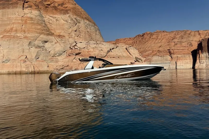 Slide: The Image of 2024 Cigarette 42' Auroris boat on calm water near rocky cliffs. - 6