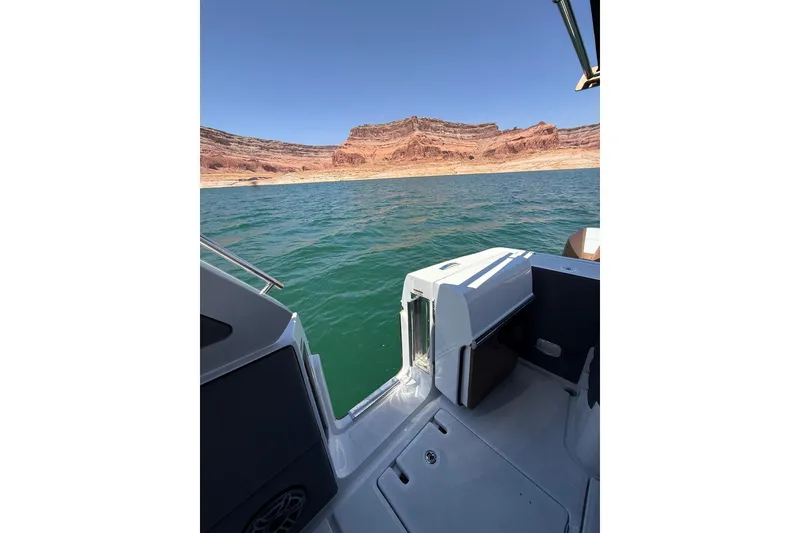 Slide: The Image of 2024 Cigarette 42' Auroris boat on a lake with rocky landscape background. - 71