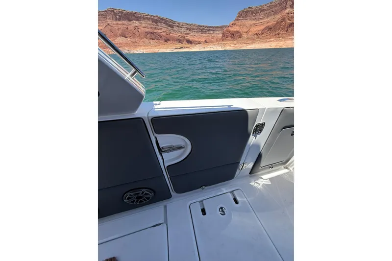 Slide: The Image of 2024 Cigarette 42' Auroris boat interior with scenic lake and canyon backdrop. - 72