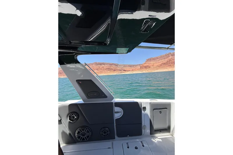 Slide: The Image of 2024 Cigarette 42' Auroris boat interior with scenic lake and rocky landscape view. - 73