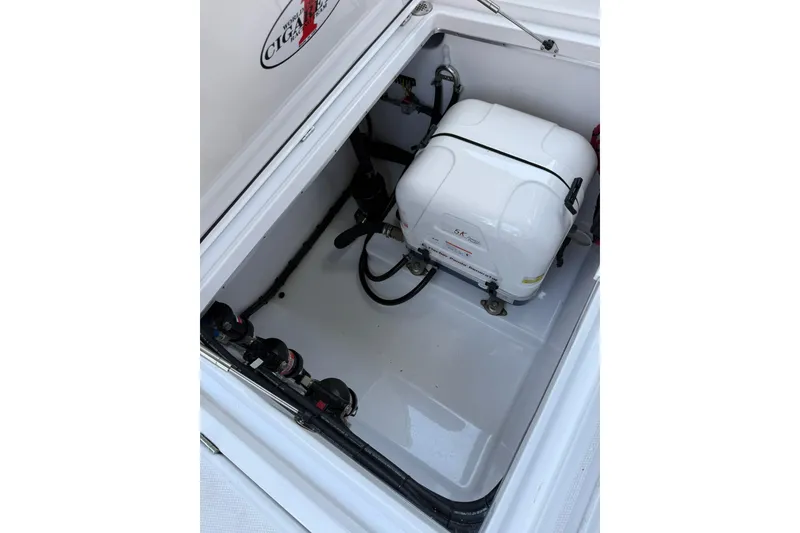 Slide: The Image of Engine compartment of 2024 Cigarette 42' Auroris boat, featuring a white generator. - 74