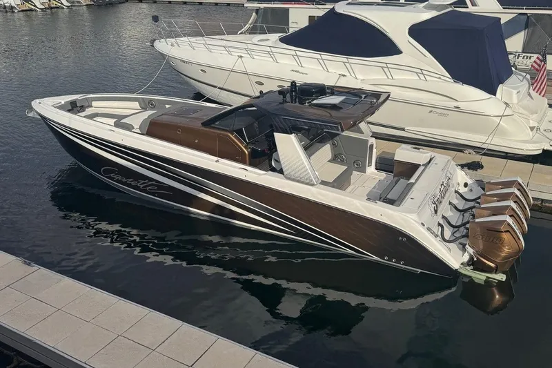 Slide: The Image of 2024 Cigarette 42' Auroris luxury boat docked at marina with sleek design. - 8