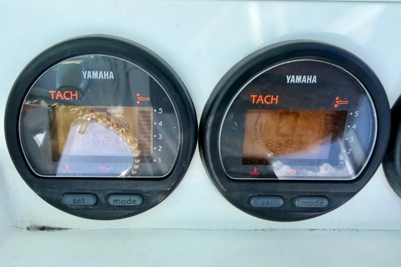 Slide: The Image of Yamaha tachometers on a 2000 Contender 35 Side Console boat dashboard. - 11