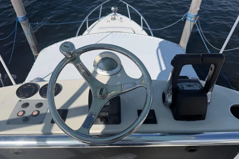 Slide: The Image of Steering console of a 2000 Contender 35 Side Console boat, docked on water. - 15