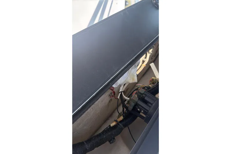 Slide: The Image of Interior view of a 2000 Contender 35 Side Console boat, showing wiring and components. - 16