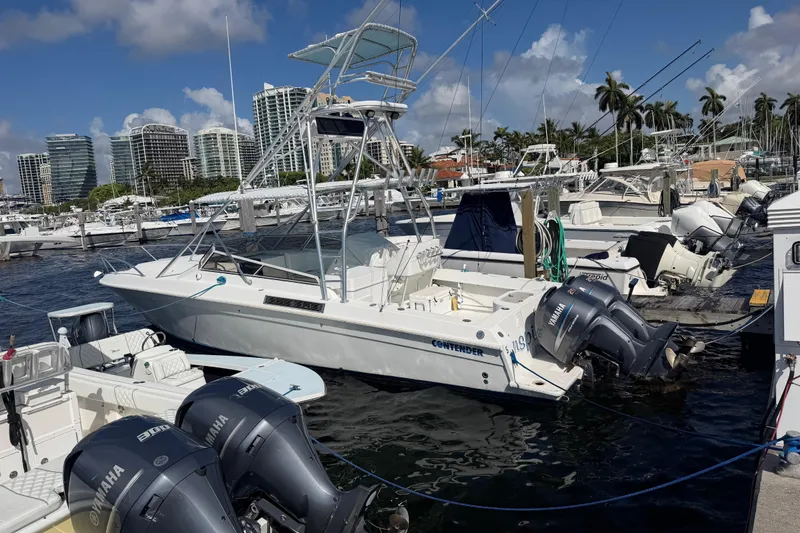 Slide: The Image of 2000 Contender 35 Side Console boat docked at marina with Yamaha engines. - 20