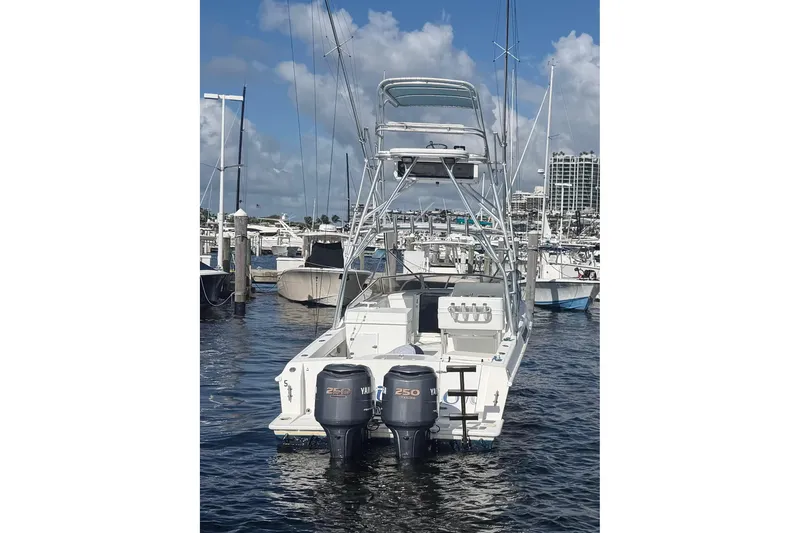 Slide: The Image of 2000 Contender 35 Side Console boat docked with twin Yamaha 250 engines. - 3