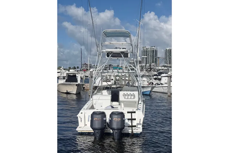Slide: The Image of 2000 Contender 35 Side Console boat docked with dual Yamaha engines. - 4