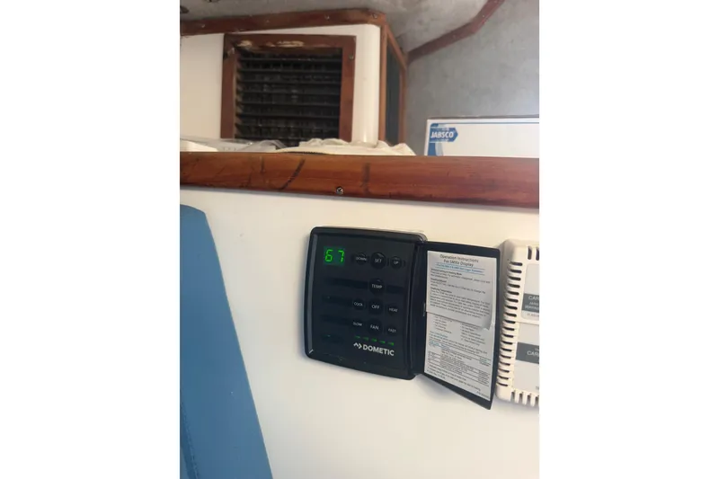 Slide: The Image of Control panel inside a 2000 Contender 35 Side Console boat, displaying temperature settings. - 8