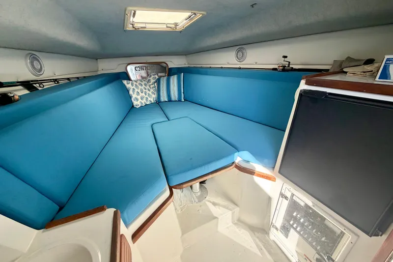 Slide: The Image of Interior of 2000 Contender 35 Side Console with blue seating and cushions. - 9