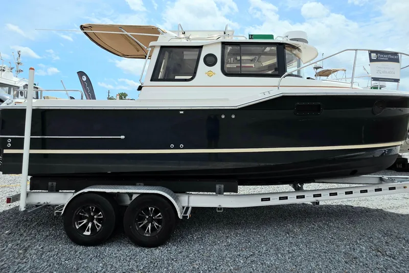 Slide: The Image of 2021 Ranger Tugs R-23 boat on trailer, side view under clear sky. - 1