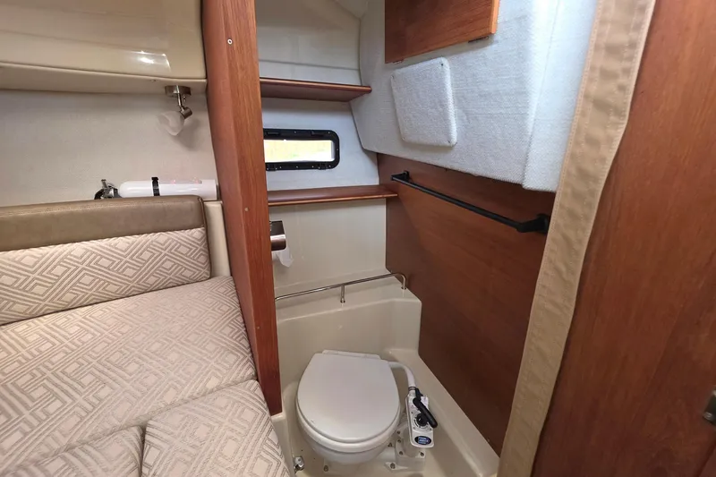 Slide: The Image of 2021 Ranger Tugs R-23 interior with compact marine toilet and cozy cabin space. - 10