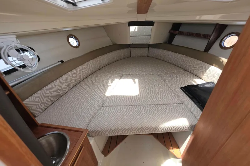 Slide: The Image of Interior cabin of 2021 Ranger Tugs R-23 boat with cozy bed and portholes. - 14