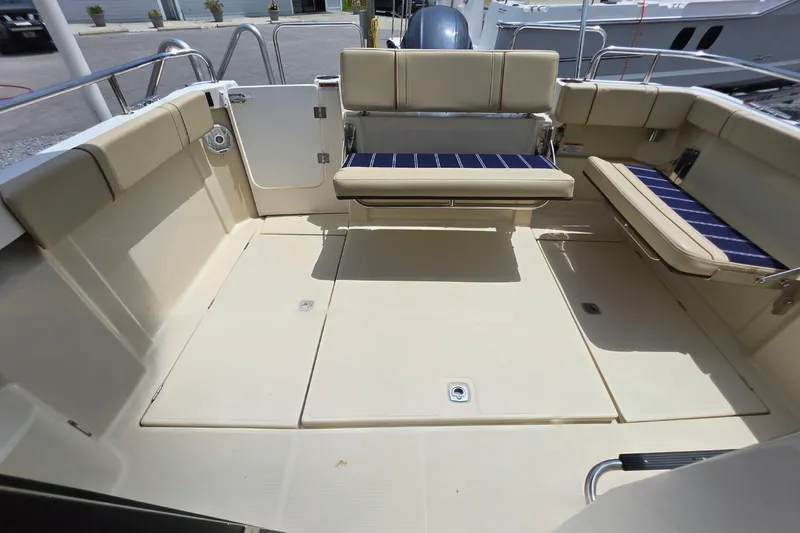 Slide: The Image of 2021 Ranger Tugs R-23 boat interior with beige seating and spacious deck area. - 3
