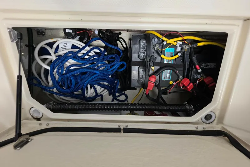 Slide: The Image of 2021 Ranger Tugs R-23 boat compartment with ropes and battery setup. - 4