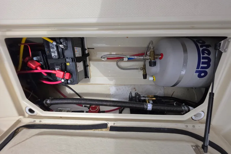 Slide: The Image of 2021 Ranger Tugs R-23 engine compartment with battery and water heater. - 5